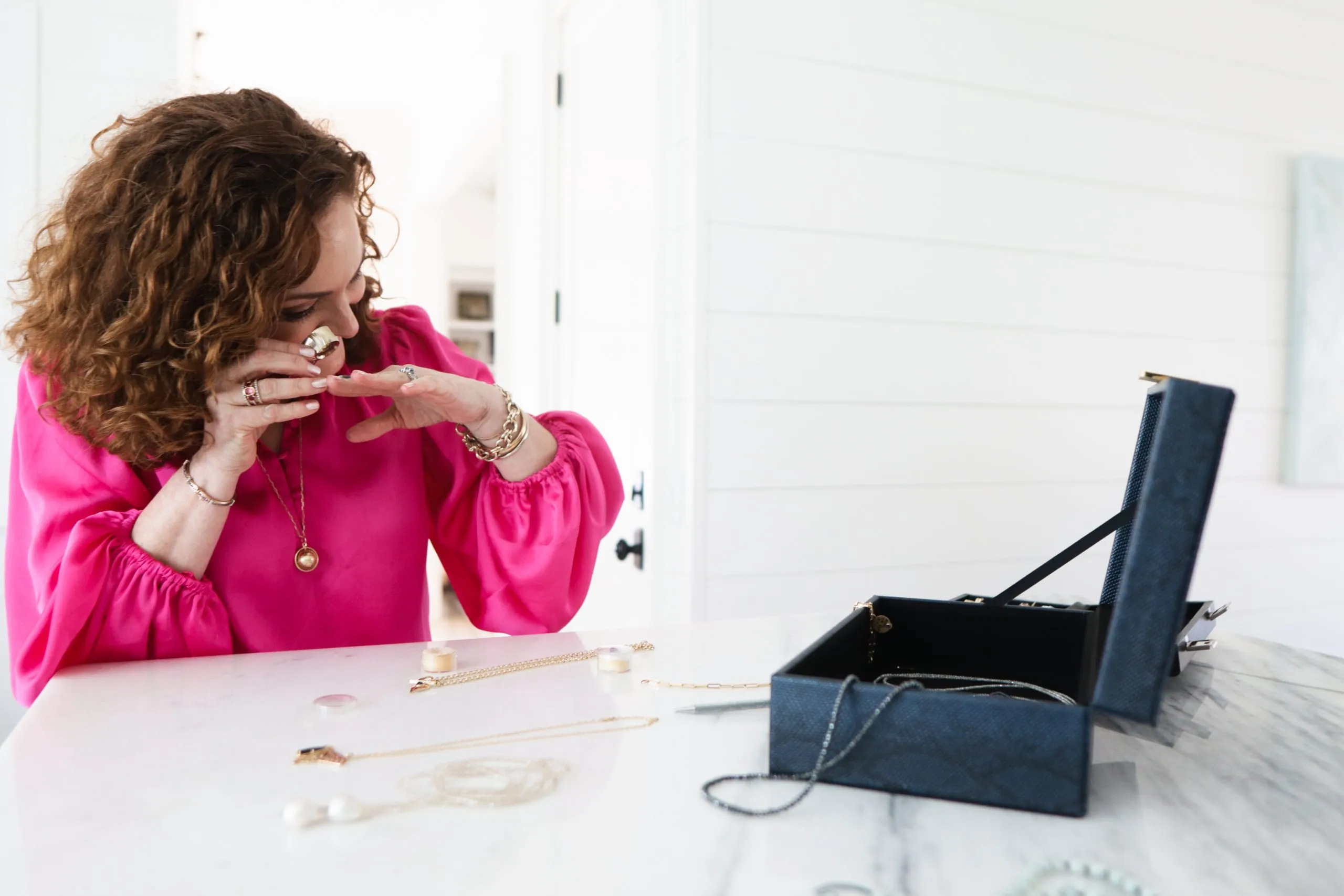 Ellen Epperson examining a custom piece during a jewelry box session at the studio